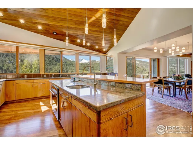 a view of a kitchen with kitchen island a large window in it