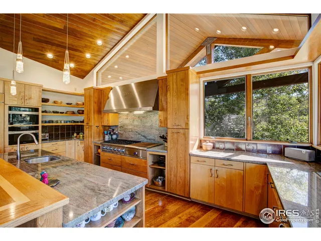 a living room with stainless steel appliances kitchen island granite countertop furniture and a kitchen view