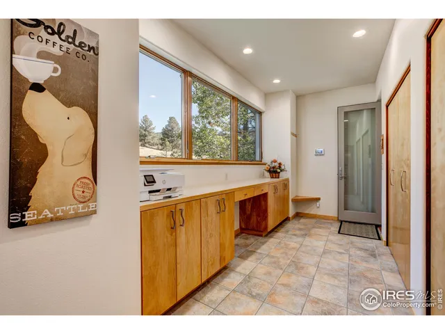 a large white kitchen with a large window