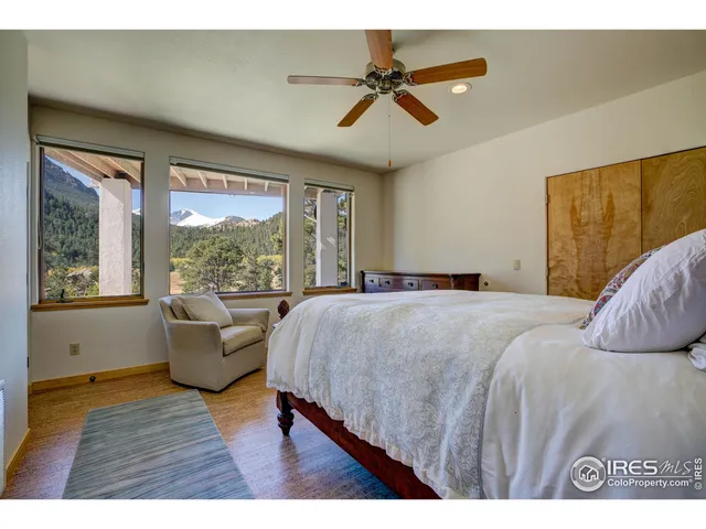 a bedroom with a large bed and a large window