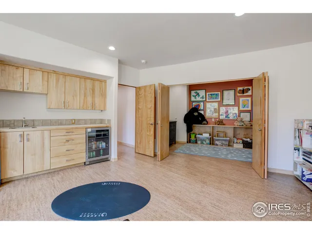 a living room with furniture and a kitchen