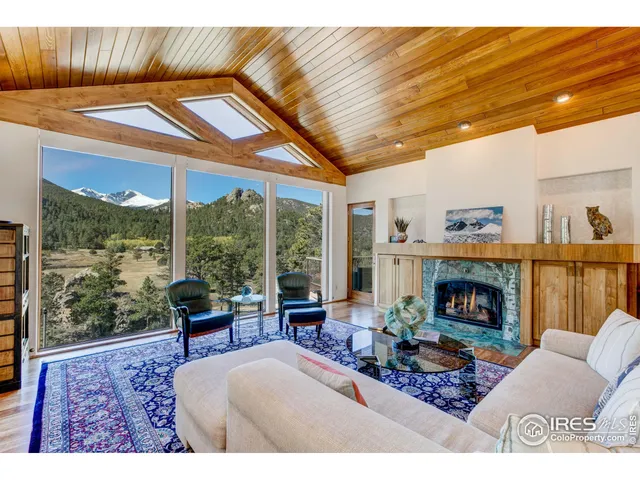 a living room with furniture a fireplace and a table