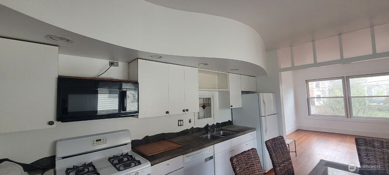 722 20th Avenue Seattle, WA 98122 - Photo 5 of 21 a kitchen with cabinets and a stove top oven