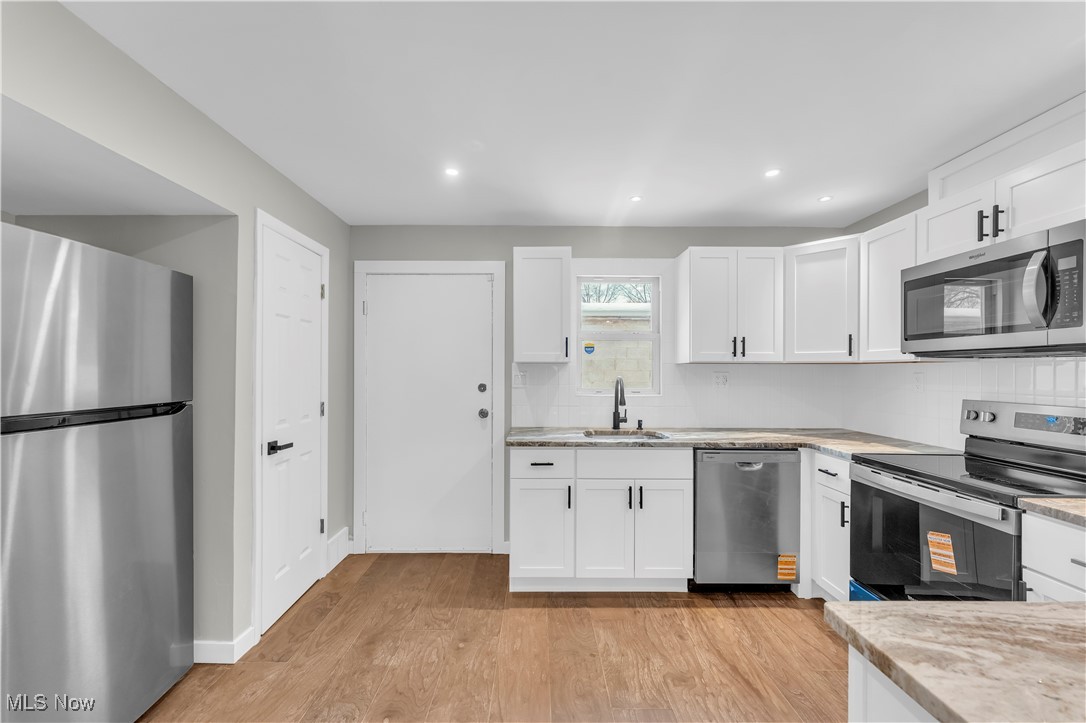 797 Babbitt Road, Unit 15 Euclid, OH 44123 - Photo 11 of 22 Kitchen with stainless steel appliances, tasteful backsplash, white cabinetry, and recessed lighting