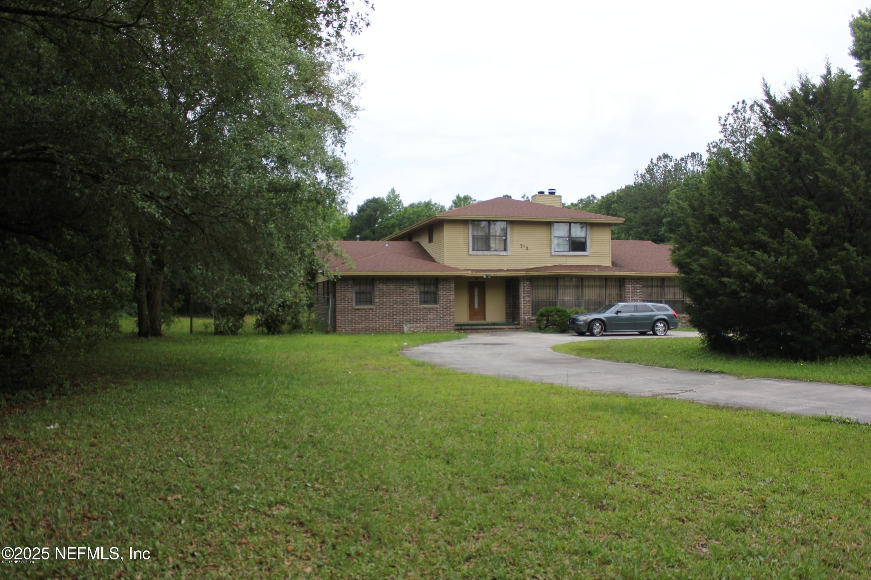 7120 Utsey Road Jacksonville, FL 32219 - Photo 1 of 1 a front view of house with yard and seating area