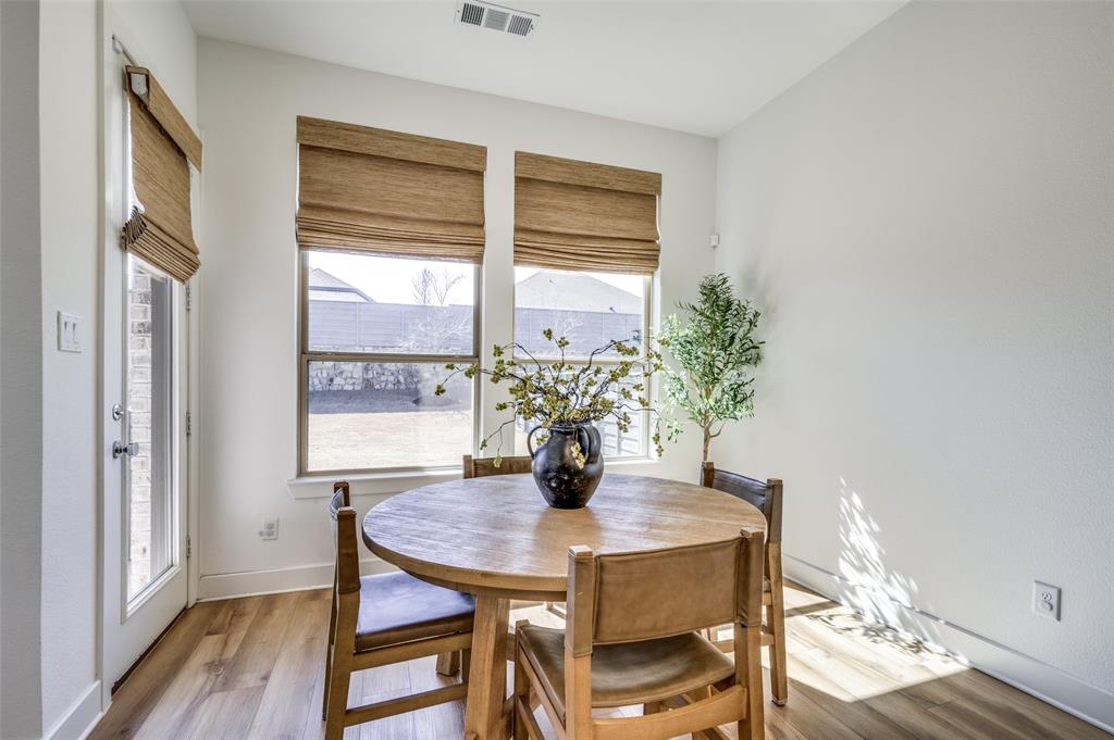 440 Sounding Street Aubrey, TX 76227 - Photo 11 of 40 a view of a dining room with furniture window and wooden floor