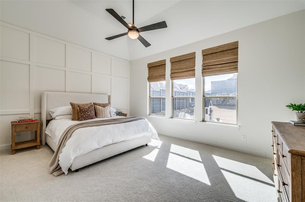 440 Sounding Street Aubrey, TX 76227 - Photo 12 of 40 a spacious bedroom with a large bed and a large window