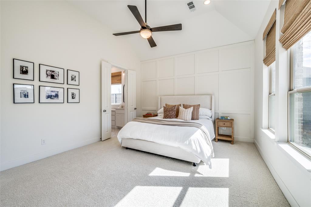 440 Sounding Street Aubrey, TX 76227 - Photo 13 of 40 a bedroom with a large bed and a ceiling fan