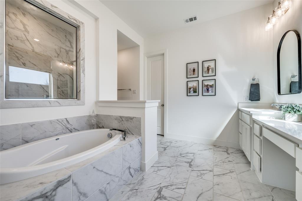 440 Sounding Street Aubrey, TX 76227 - Photo 15 of 40 a bathroom with a tub sink and mirror