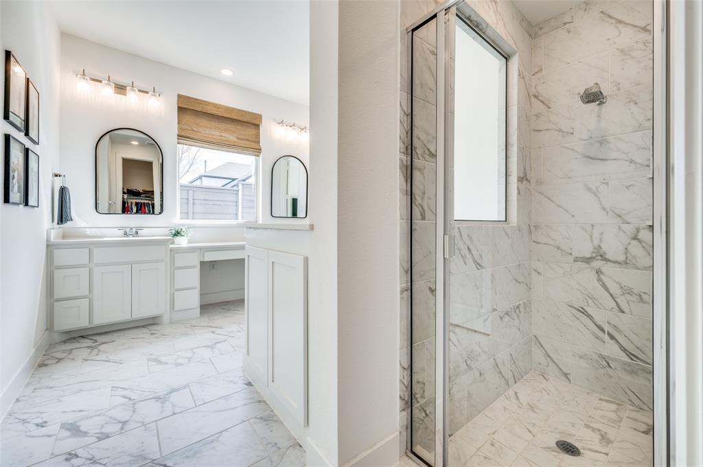440 Sounding Street Aubrey, TX 76227 - Photo 16 of 40 a bathroom with a sink a mirror and shower