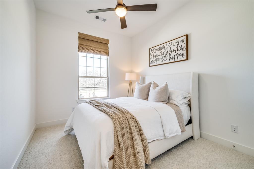 440 Sounding Street Aubrey, TX 76227 - Photo 20 of 40 a large bed sitting in a bedroom next to a window