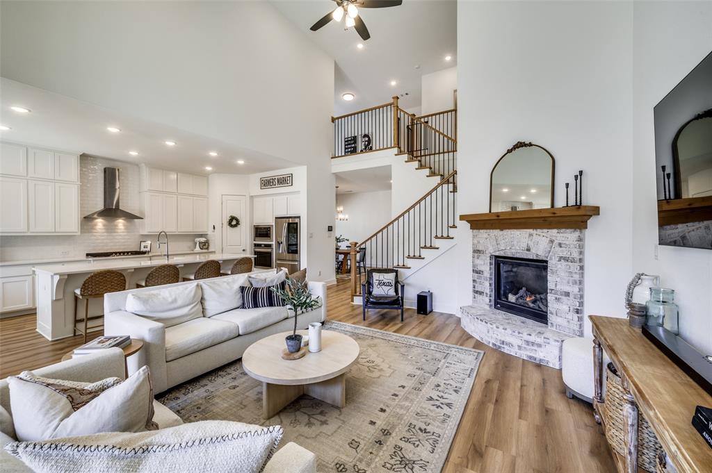 440 Sounding Street Aubrey, TX 76227 - Photo 3 of 40 a living room with furniture and a fireplace