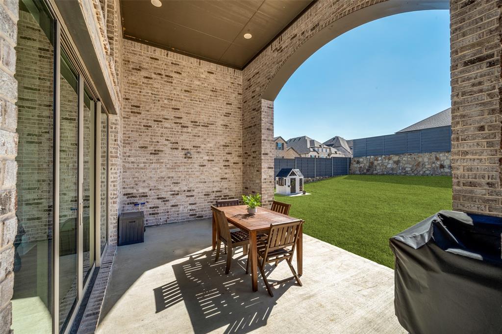 440 Sounding Street Aubrey, TX 76227 - Photo 34 of 40 a patio with table and chairs and potted plants