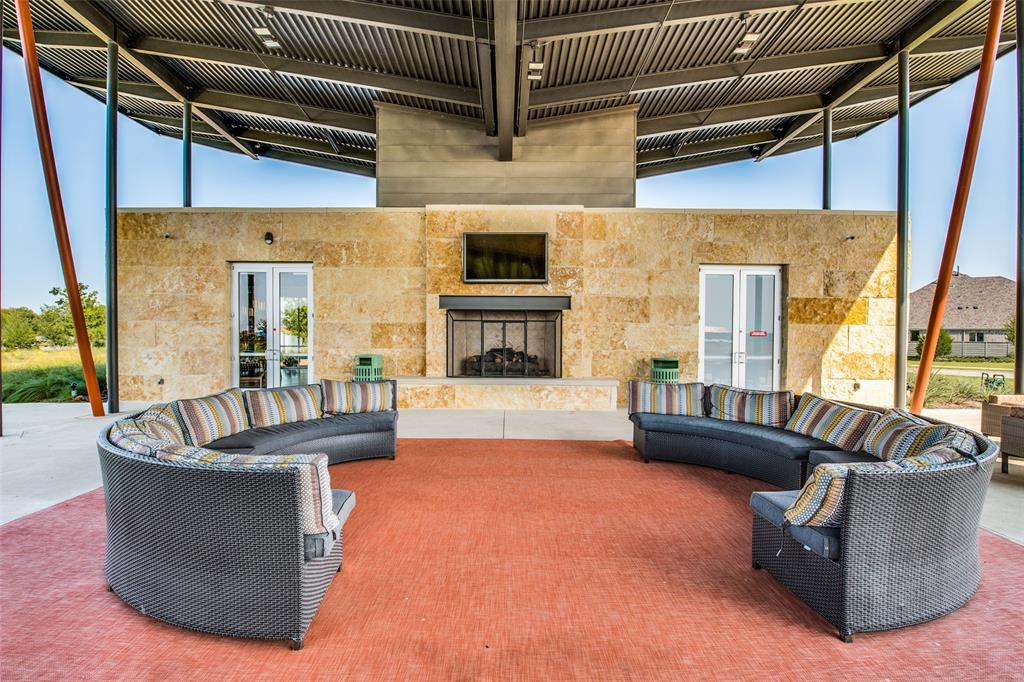 440 Sounding Street Aubrey, TX 76227 - Photo 39 of 40 a living room with couches and a fireplace
