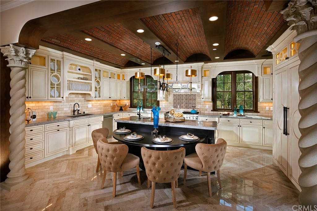 a kitchen with a table chairs stove and cabinets