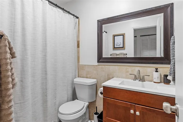 a bathroom with a toilet a sink and a mirror