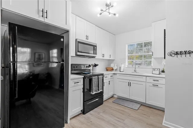 a kitchen with cabinets and stainless steel appliances
