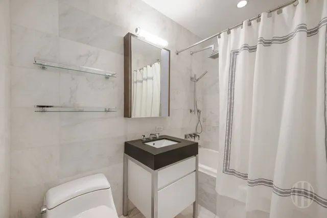 a bedroom with a large bed and a large window