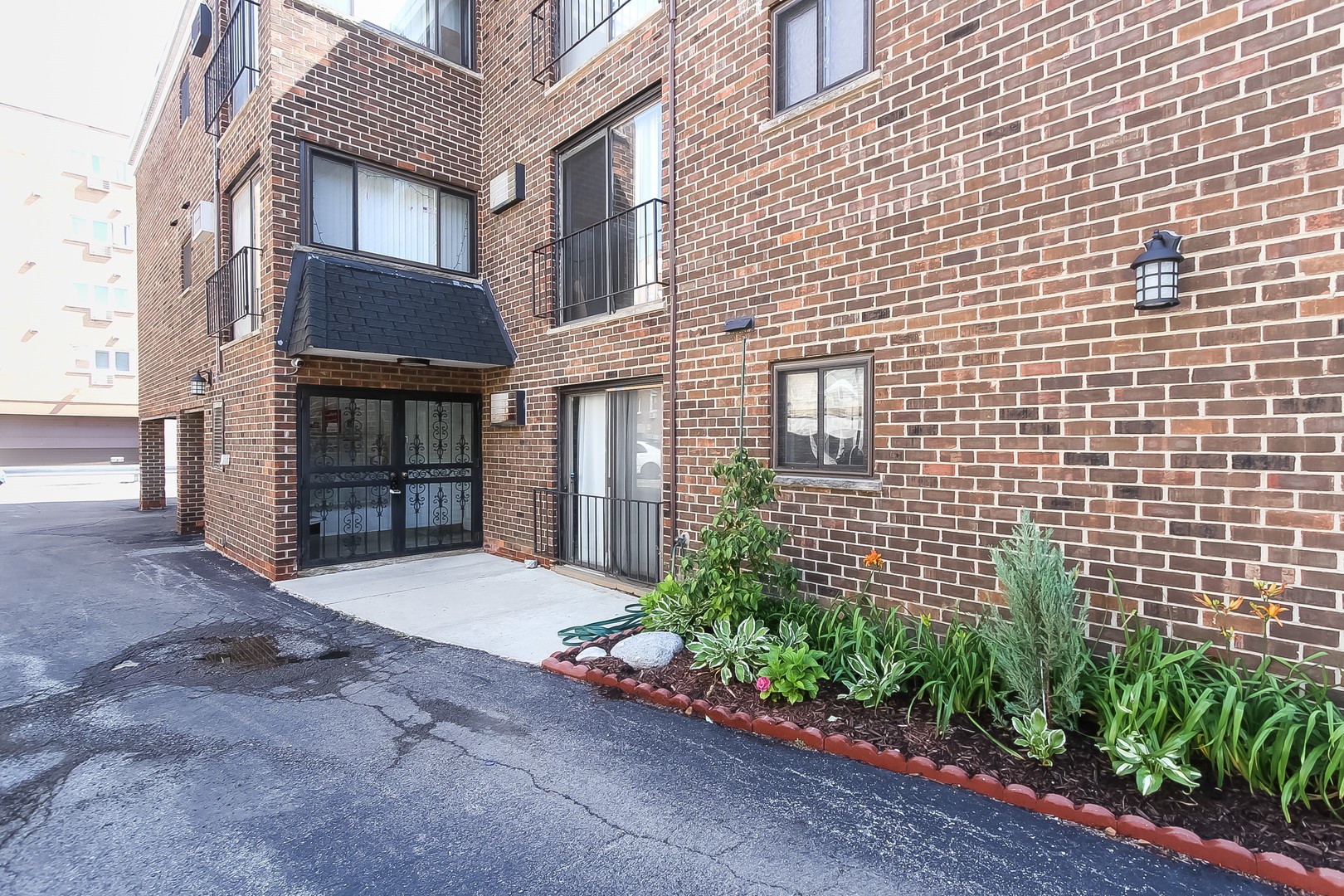 1650 Mill Street, Unit 103 Des Plaines, IL 60016 - Photo 2 of 19 a view of a brick house with a large windows