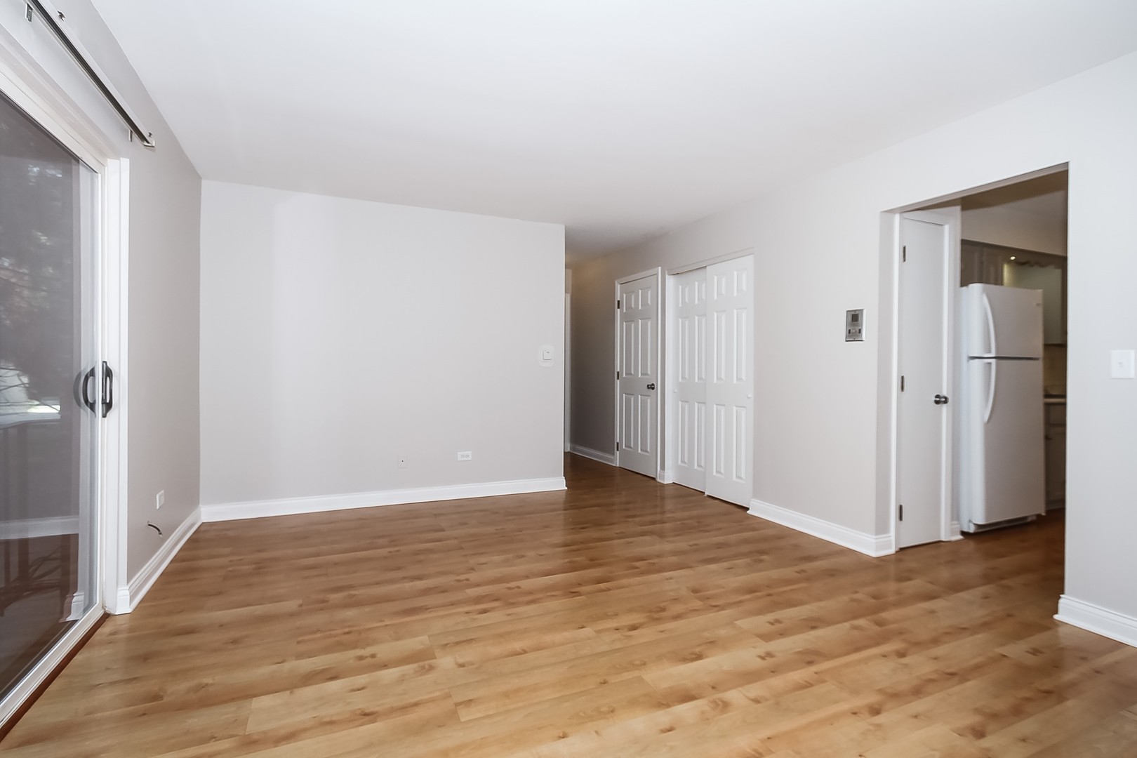 1650 Mill Street, Unit 103 Des Plaines, IL 60016 - Photo 5 of 19 a view of an empty room with wooden floor and a bathroom