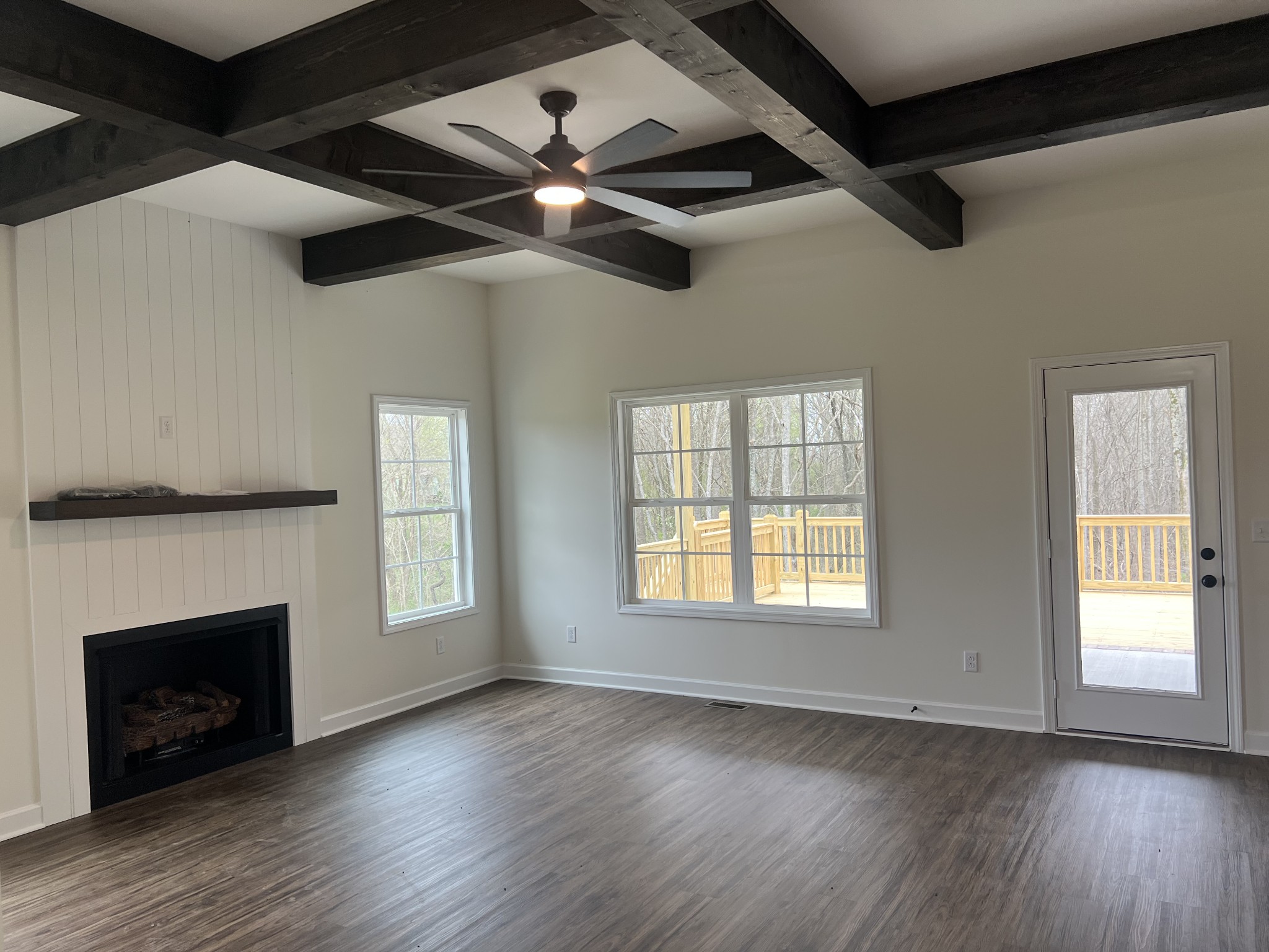 980 Hurricane Ridge Road Smithville, TN 37166 - Photo 4 of 5 a view of an empty room with wooden floor fireplace and a window