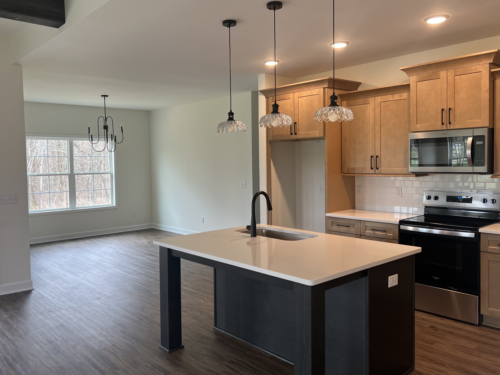 980 Hurricane Ridge Road Smithville, TN 37166 - Photo 5 of 5 a kitchen with a sink a center island wooden floor and stainless steel appliances