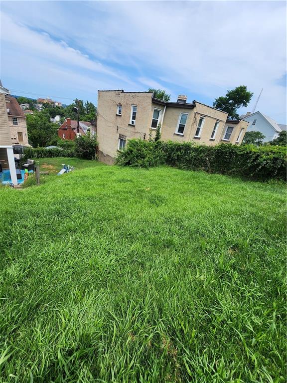311 Natchez Street Pittsburgh, PA 15211 - Photo 13 of 17 a backyard of a house with lots of green space and garden view