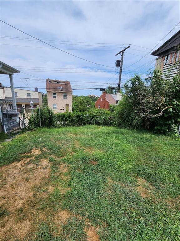 311 Natchez Street Pittsburgh, PA 15211 - Photo 7 of 17 a front view of a house with a yard and garage