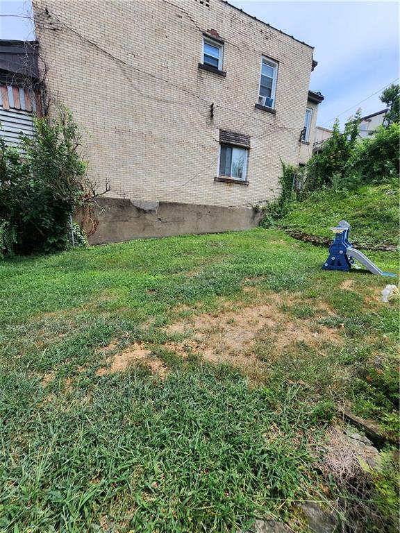 311 Natchez Street Pittsburgh, PA 15211 - Photo 9 of 17 a view of a backyard with plants and a bench