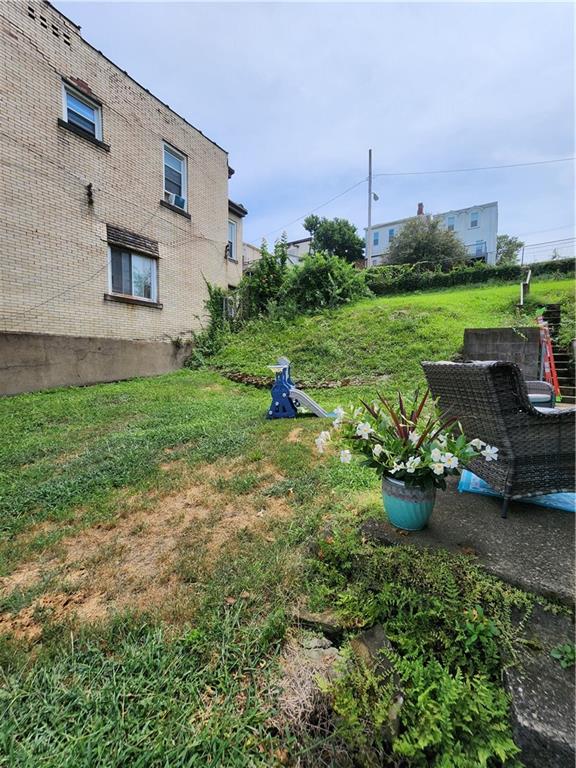 311 Natchez Street Pittsburgh, PA 15211 - Photo 10 of 17 a view of a backyard with plants and a garden