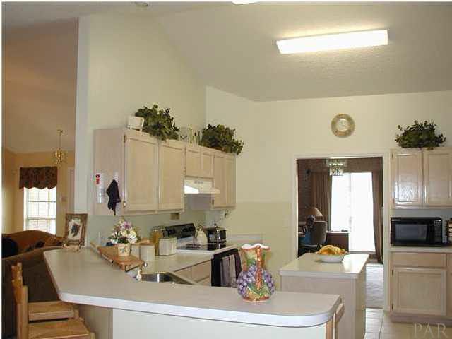 2401 Crescent Road Navarre, FL 32566 - Photo 3 of 9 Island kitchen with breakfast bar and lots of cupboard space.