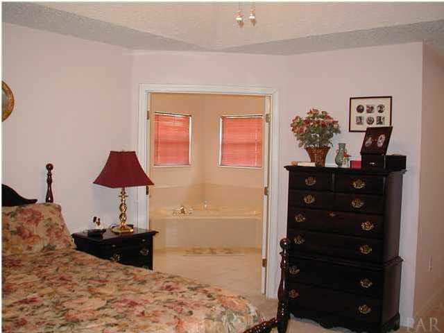 2401 Crescent Road Navarre, FL 32566 - Photo 6 of 9 The master bedroom with French doors that lead to the master bath.