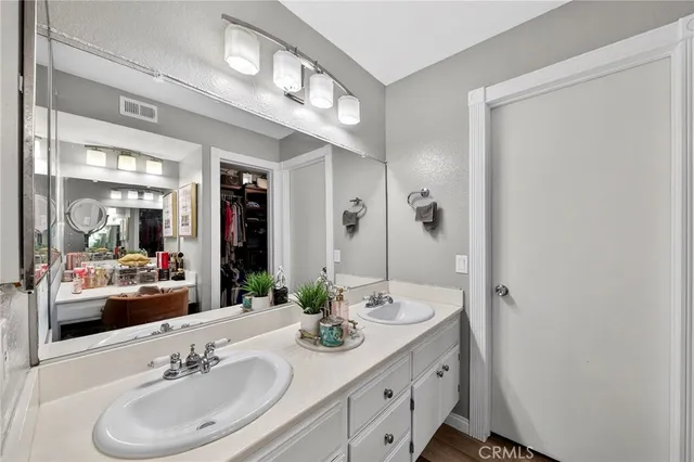 a bathroom with a sink double vanity and a mirror