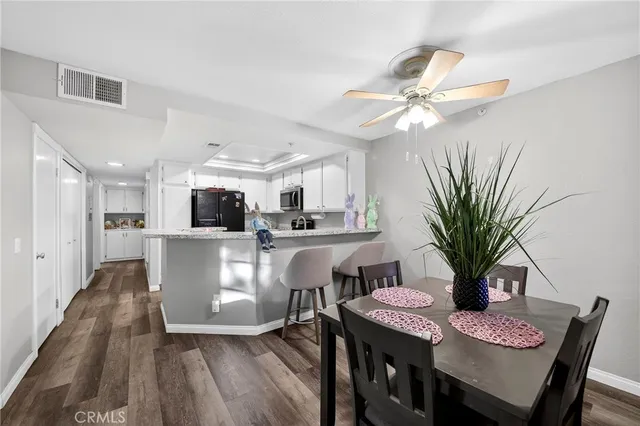 a view of a dining room with furniture and wooden floor