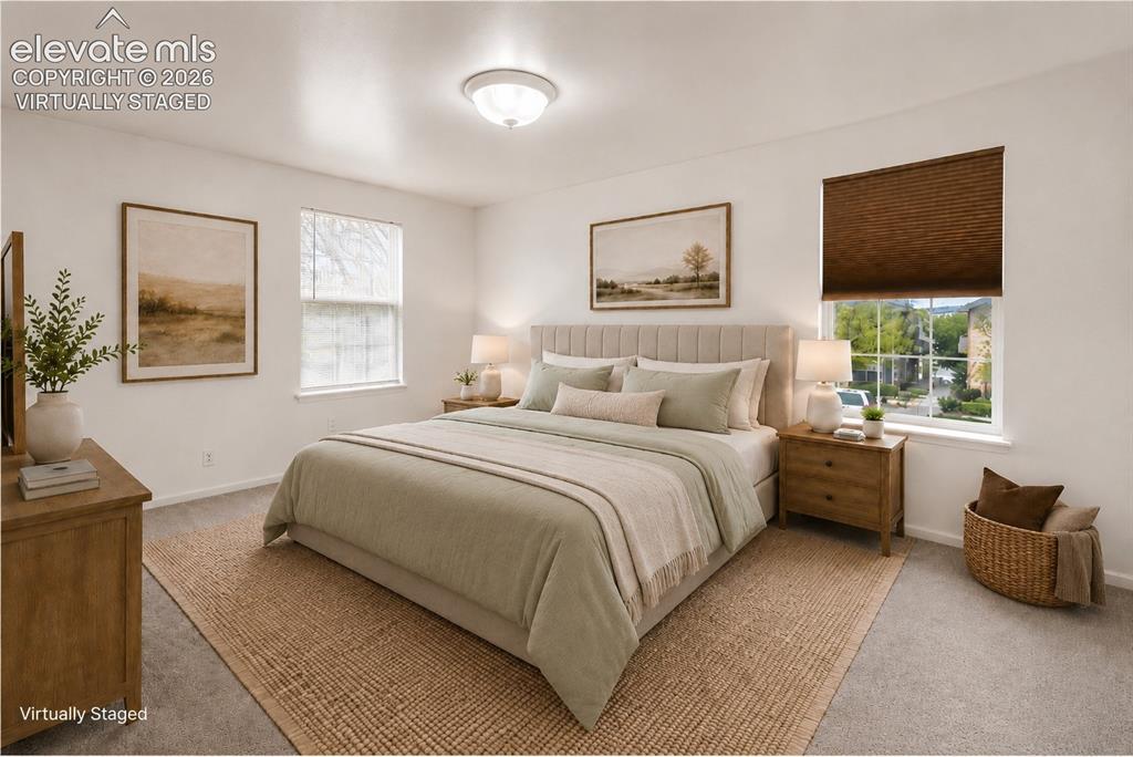 1563 Monterey Road, Unit D Colorado Springs, CO 80910 - Photo 7 of 22 a spacious bedroom with a bed and glass windows