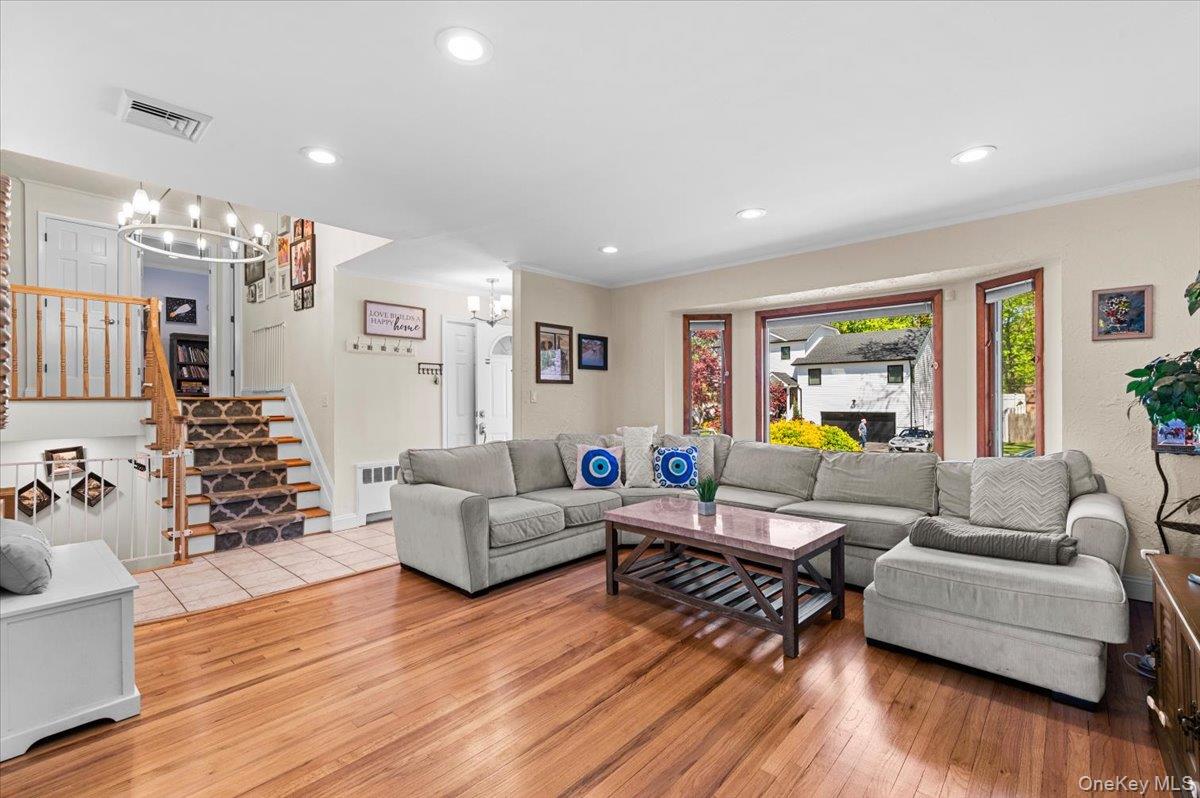 61 Winthrop Road Plainview, NY 11803 - Photo 3 of 37 a living room with furniture and wooden floor