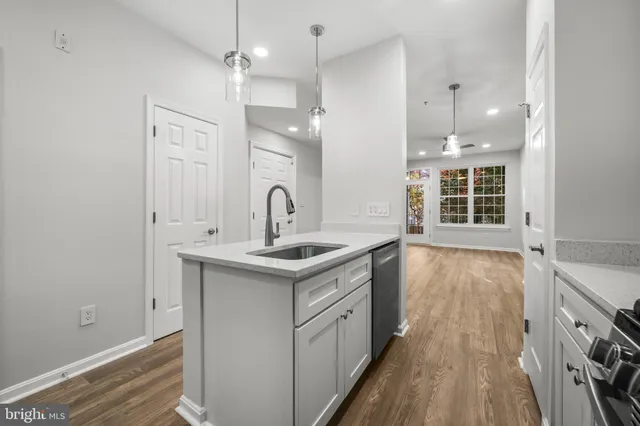 a kitchen with a sink stove and cabinets