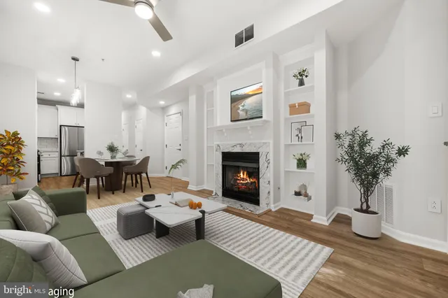 a living room with furniture and a fireplace