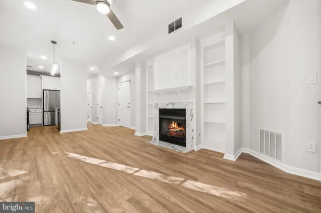 a view of an empty room with a fireplace