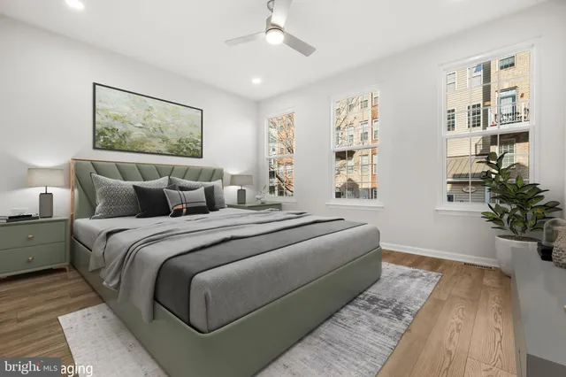 a bedroom with bed and wooden floor