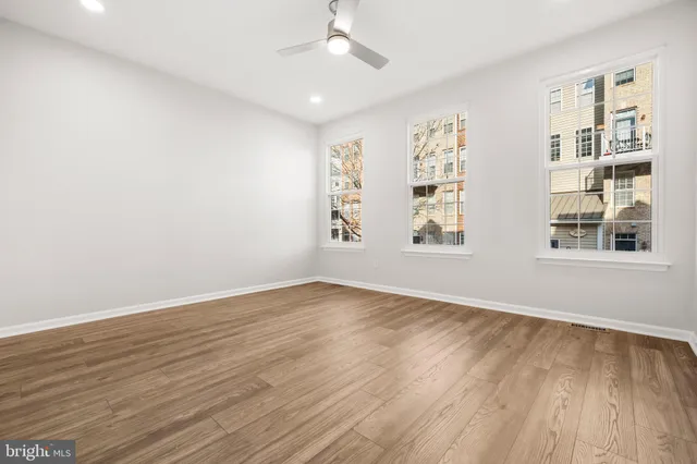 wooden floor in an empty room with a window