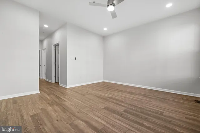a view of an empty room with wooden floor