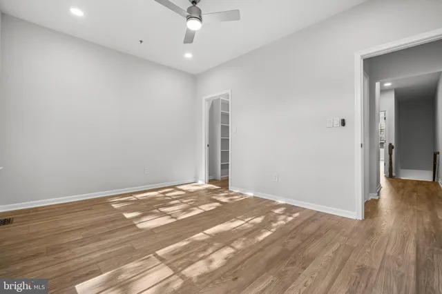 a view of an empty room with wooden floor