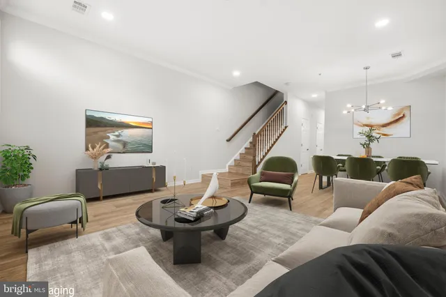 a living room with furniture and a chandelier