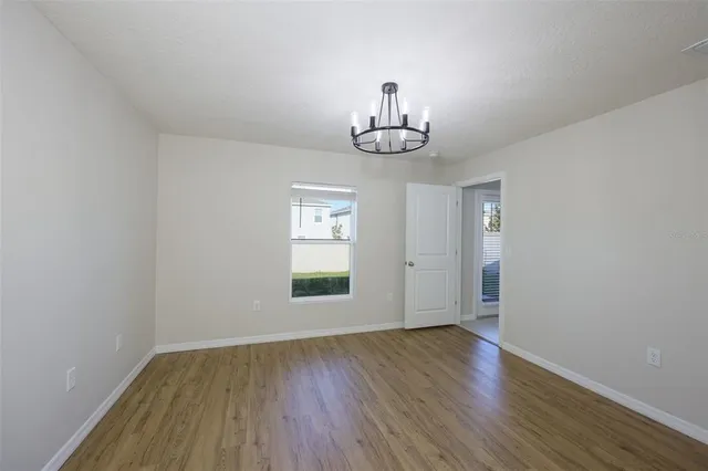 a view of wooden floor and chandelier in a room