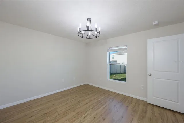 an empty room with wooden floor