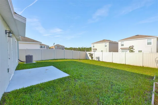 a backyard of a house with table and chairs