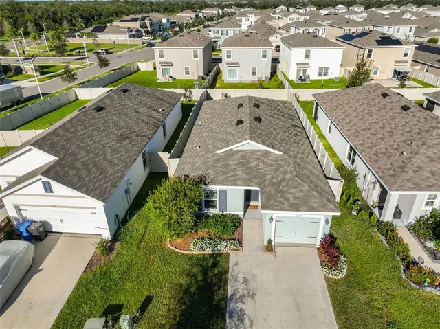 an aerial view of a house with a yard basket ball court and outdoor seating