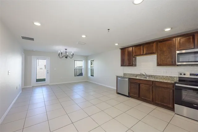 a kitchen with stainless steel appliances granite countertop a sink and cabinets