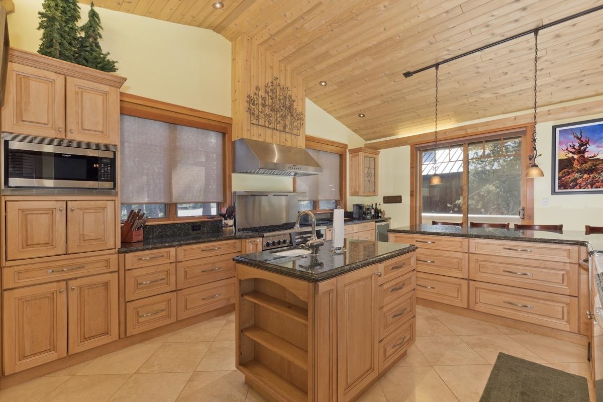 2500 Old Mammoth Road Mammoth Lakes, CA 93546 - Photo 18 of 48 a kitchen with stainless steel appliances granite countertop a stove a sink and a microwave
